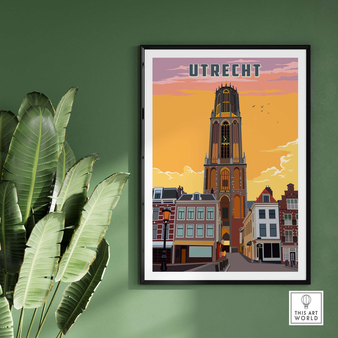 Framed poster of the Dom Tower in Utrecht at sunset in a black frame on a green wall. 