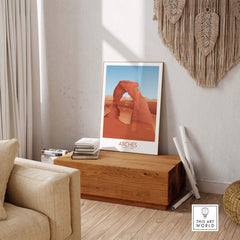 Arches National Park art print displayed in a cozy living room setting with wooden bench and decorative accents.