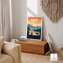 Banff National Park poster displayed in a stylish living room, showcasing mountains and wildlife, perfect for home decor.