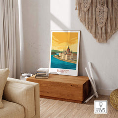 Stylish Budapest poster framed in a cozy interior, showcasing vintage travel art with a cityscape design.