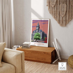 Manchester Art Print featuring vintage style illustration of Manchester architecture, framed and displayed in a stylish living room.