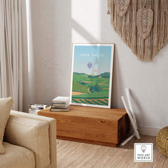 Napa Valley Print Wall Art Poster framed in a cozy living space with a wooden table and decorative home accessories.