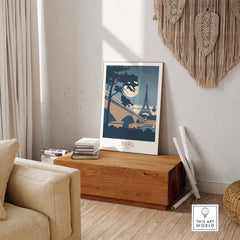 Moonlit Paris France travel poster displayed on a wooden table, adding vintage charm to home decor.