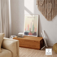 Philadelphia skyline poster in warm pastel tones displayed in a stylish living room setting.