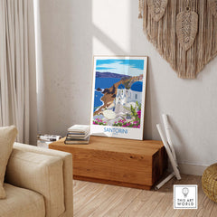 Santorini travel poster art print showcasing blue domes and coastal scenery in a stylish interior setting.
