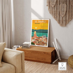 St Tropez France Print Poster Wall Art on wooden table, showcasing vibrant coastal scenery and vintage style.