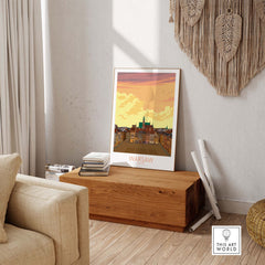 Warsaw Print Poland poster displayed in a stylish living room on a wooden table, showcasing vibrant colors and travel-inspired design.