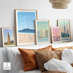 Cape Town print and other city artwork displayed in minimalist frames on a stylish sofa, enhancing home decor.