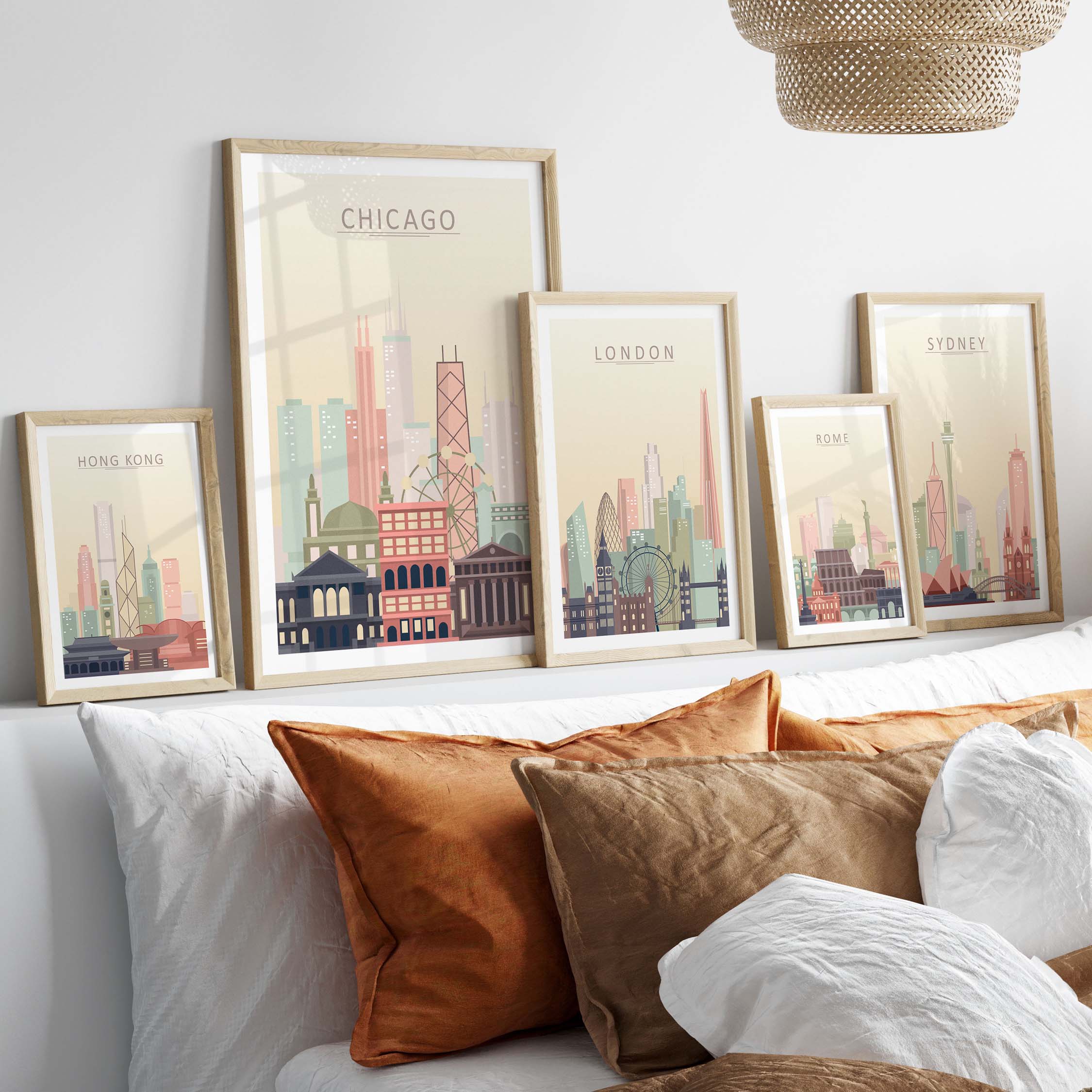 Framed city skyline wall art featuring Chicago, London, Sydney, and Hong Kong in warm pastel tones on a stylish bedroom wall.