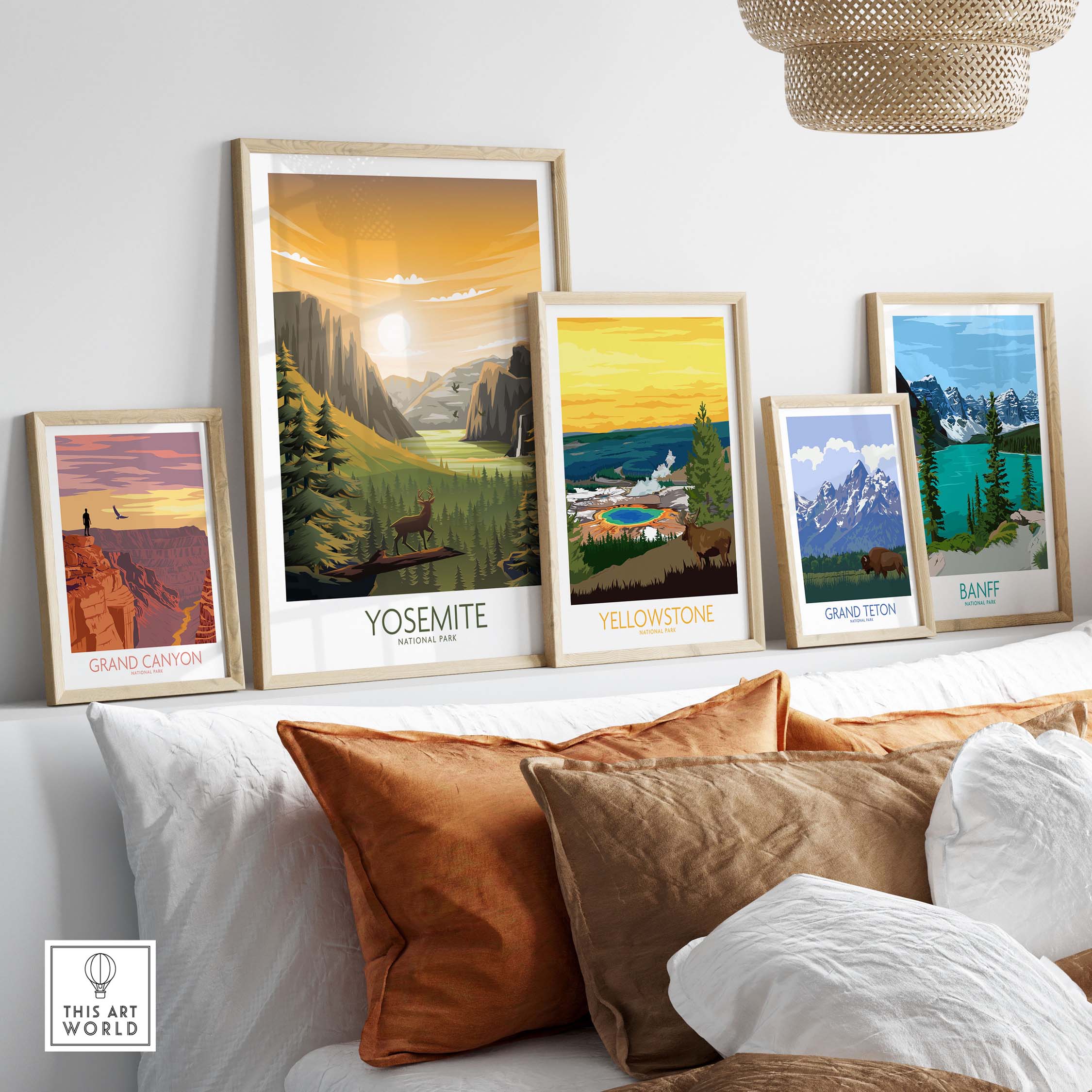 Framed Yosemite, Yellowstone, Grand Canyon, and Banff wall art prints displayed in a stylish living space with decorative pillows.