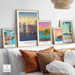 Amsterdam wall art print displayed with vintage-inspired travel posters on a cozy sofa.