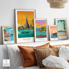 Colorful Bangkok travel poster displayed among other vintage travel prints in a modern home setting.