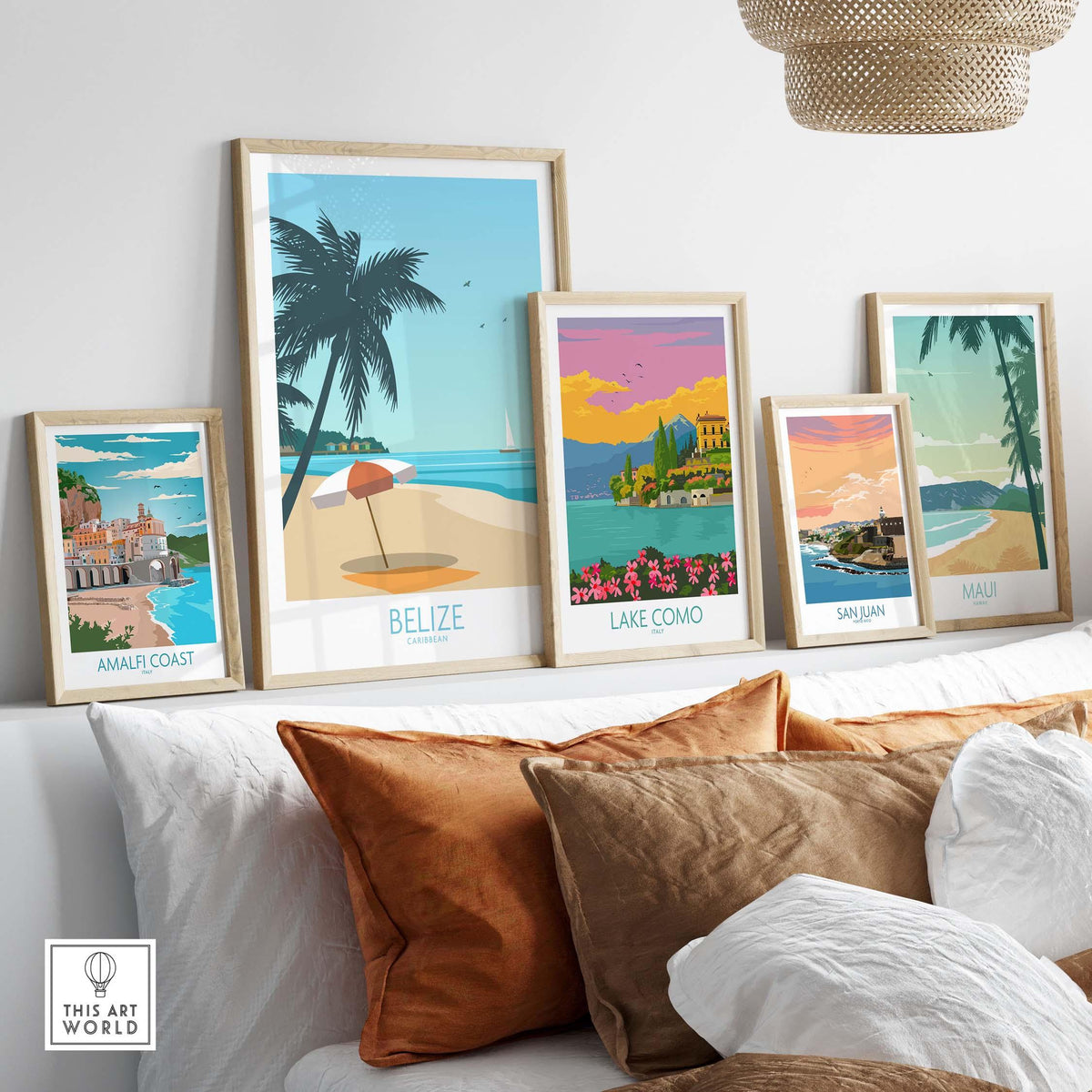 Colorful vintage travel posters including Belize, Lake Como, and Amalfi Coast displayed on a stylish couch.