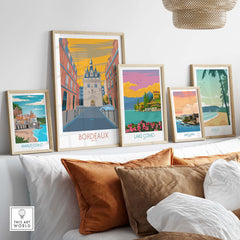 Bordeaux travel poster and vintage art prints displayed in a stylish home setting with cozy cushions.