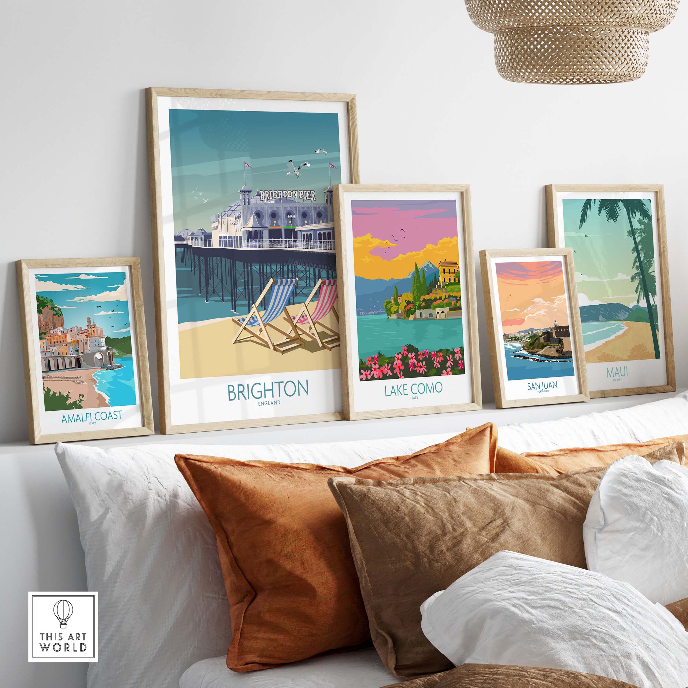 Stylish travel poster prints featuring Brighton, Lake Como, San Juan, Amalfi Coast, and Maui in a modern home decor setting.