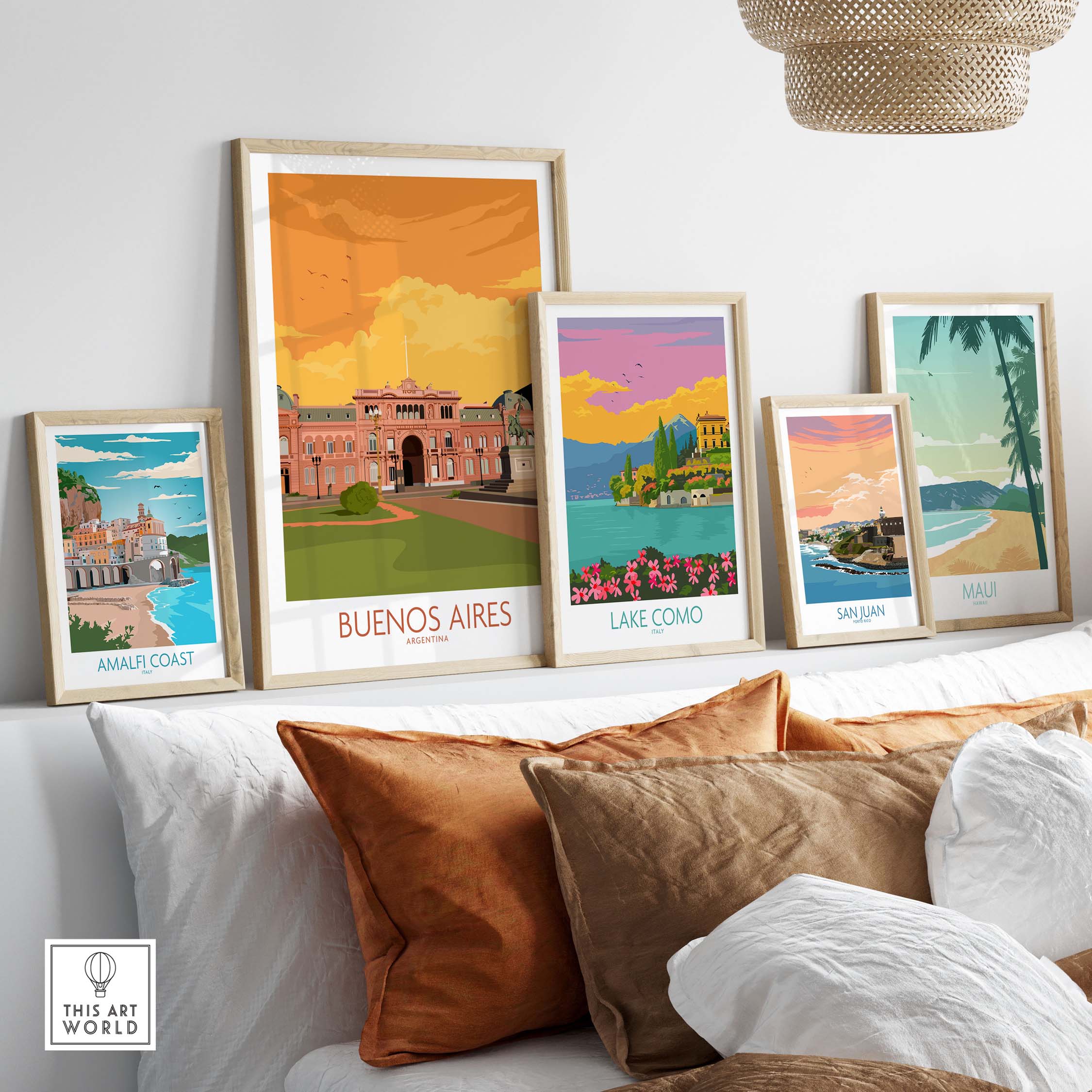 Buenos Aires poster displayed among vintage travel art prints on a stylish shelf with decorative pillows.