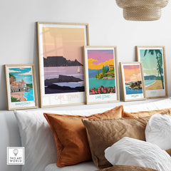 Stylish Cape Town poster print among other travel art prints on a stylish shelf with decorative pillows.