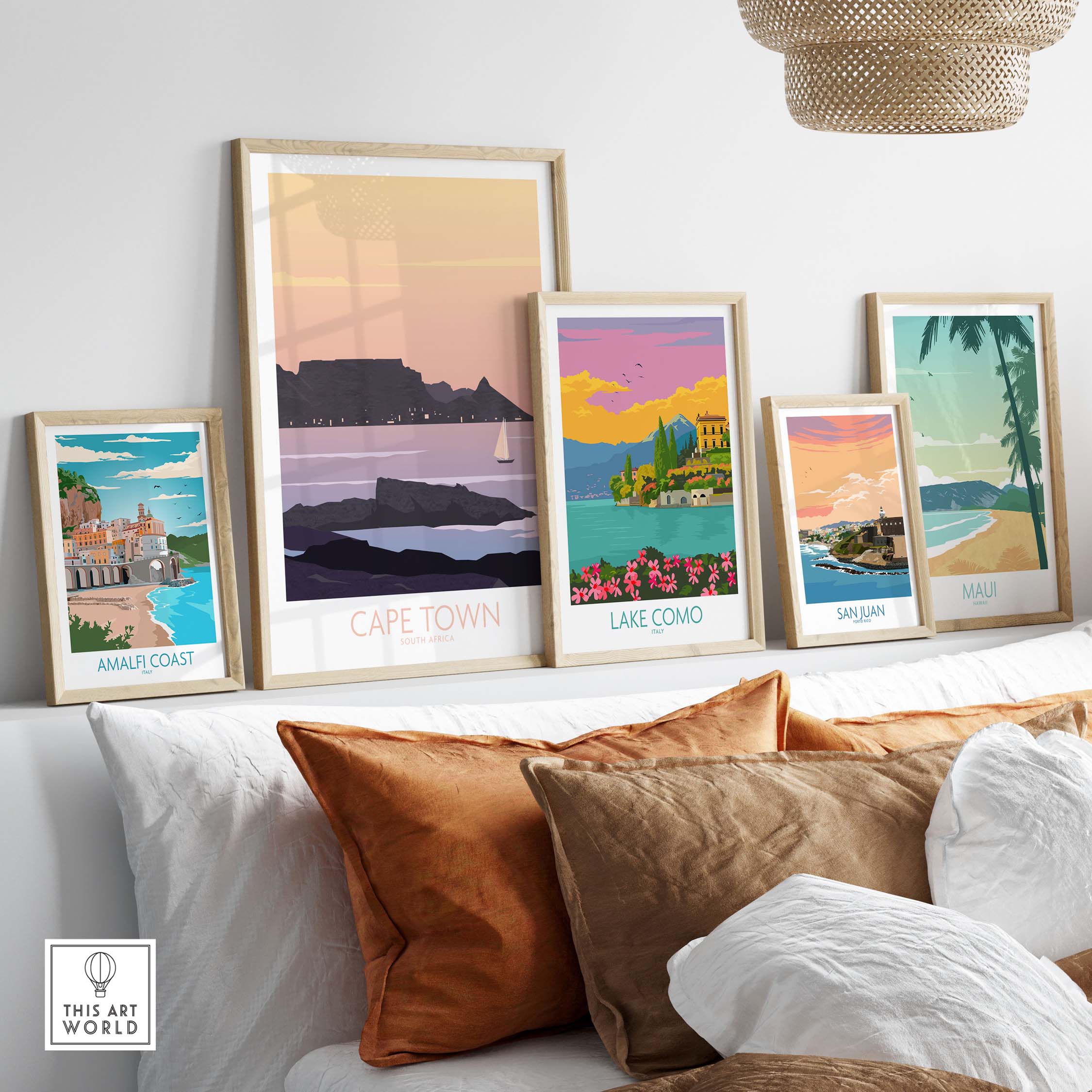 Stylish Cape Town poster print among other travel art prints on a stylish shelf with decorative pillows.