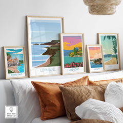 Cornwall poster print and other vintage travel artwork framed on a wall, showcasing coastal landscapes.