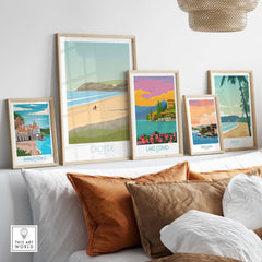 Croyde Beach Print and vintage travel posters displayed in framed art, showcasing scenic destinations like Amalfi Coast and Lake Como.