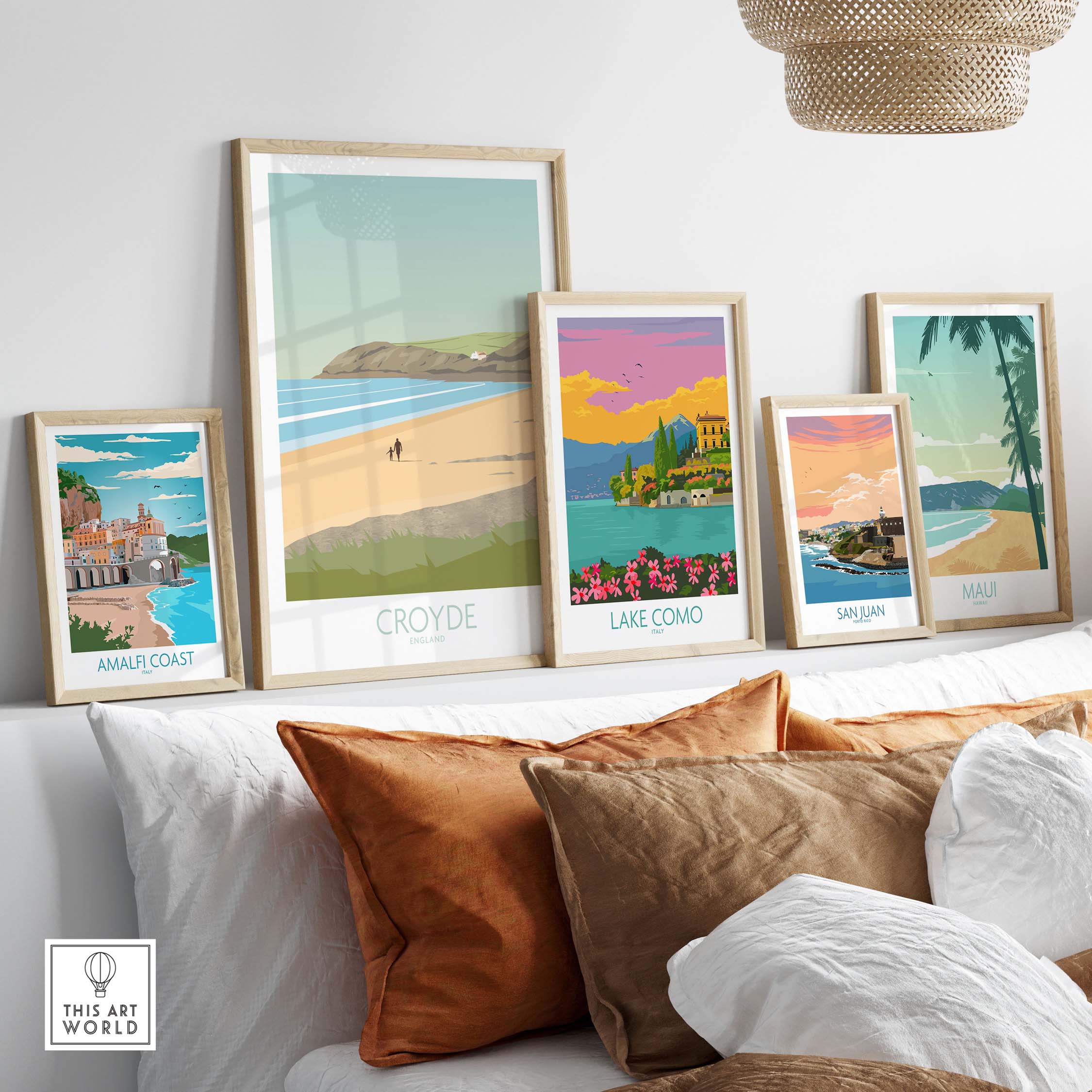 Croyde Beach Print and vintage travel posters displayed in framed art, showcasing scenic destinations like Amalfi Coast and Lake Como.