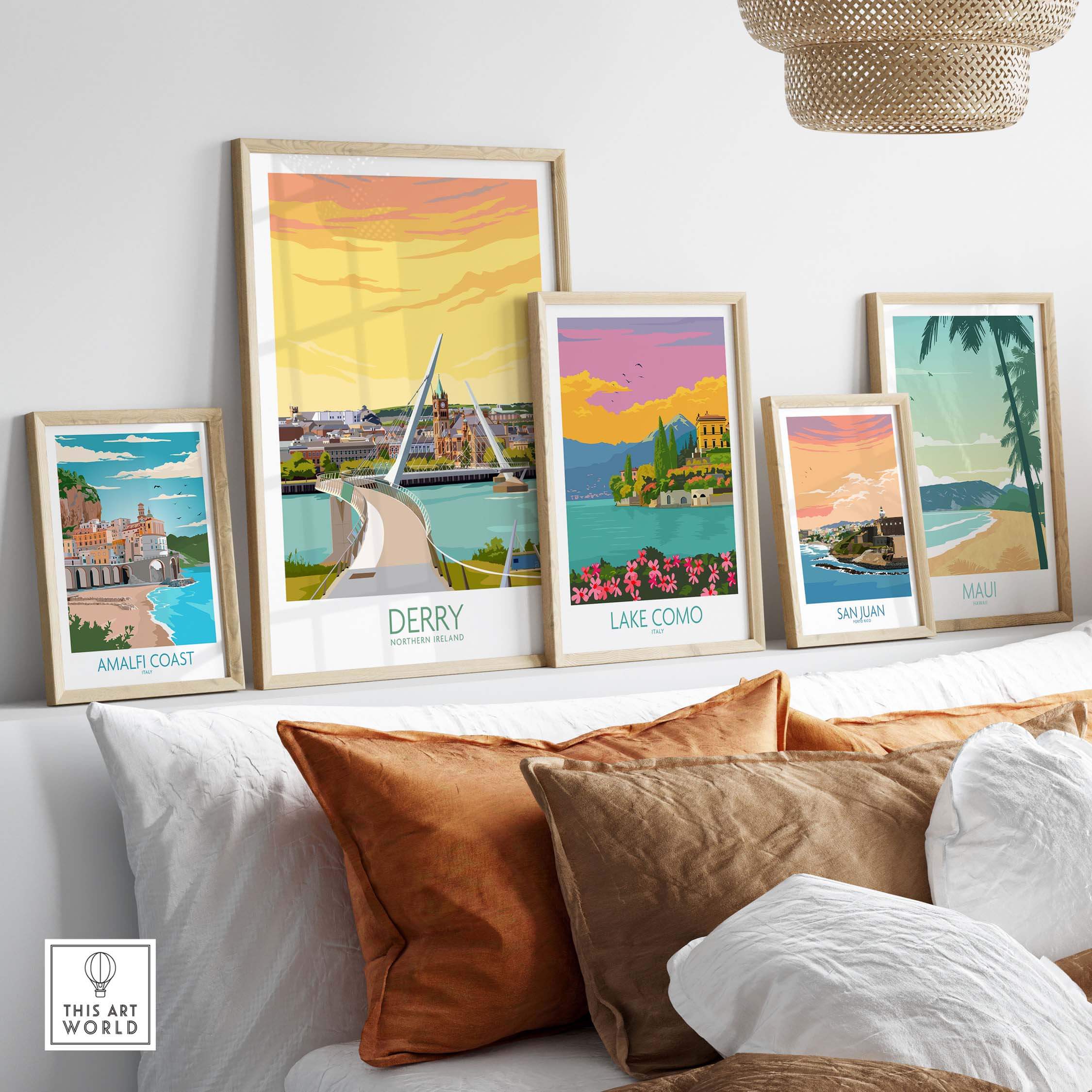 Framed Derry Print and other travel art posters displayed on a stylish sofa in a cozy living room setting.