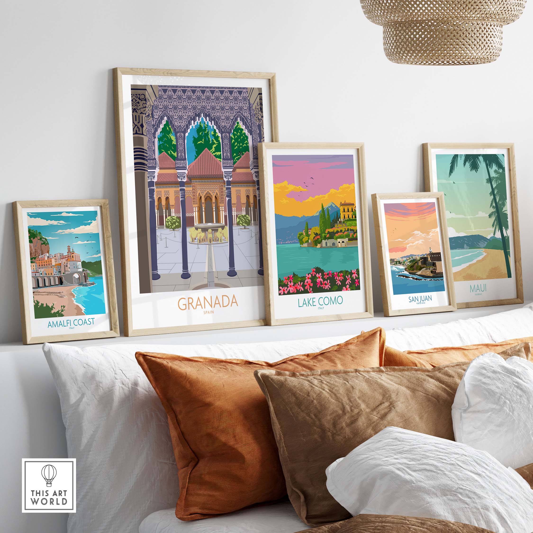 Stylish travel poster prints of Granada, Lake Como, Amalfi Coast, San Juan, and Maui displayed in a modern living room.