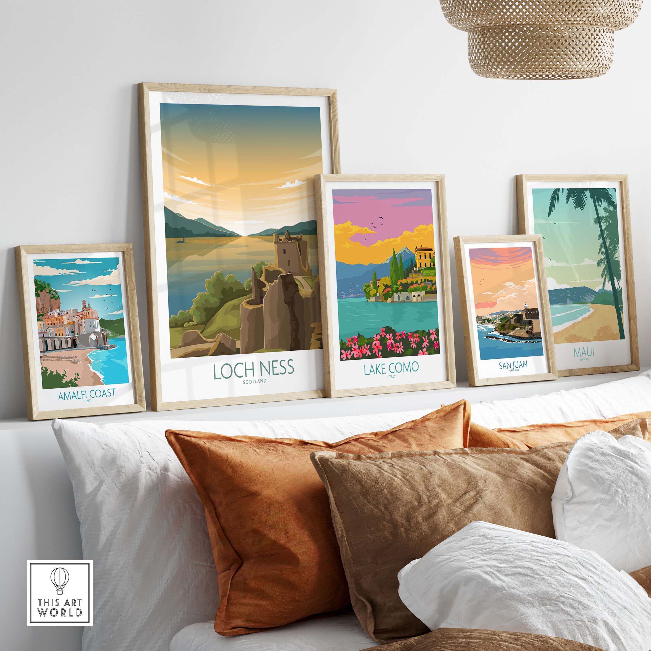 Loch Ness print among framed vintage-style travel posters on a stylish sofa, showcasing Scotland's beauty.