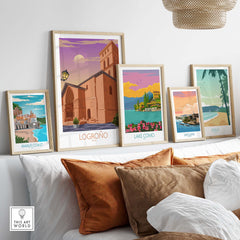 Logrono Spain poster and other vintage travel art displayed on a shelf with decorative pillows.