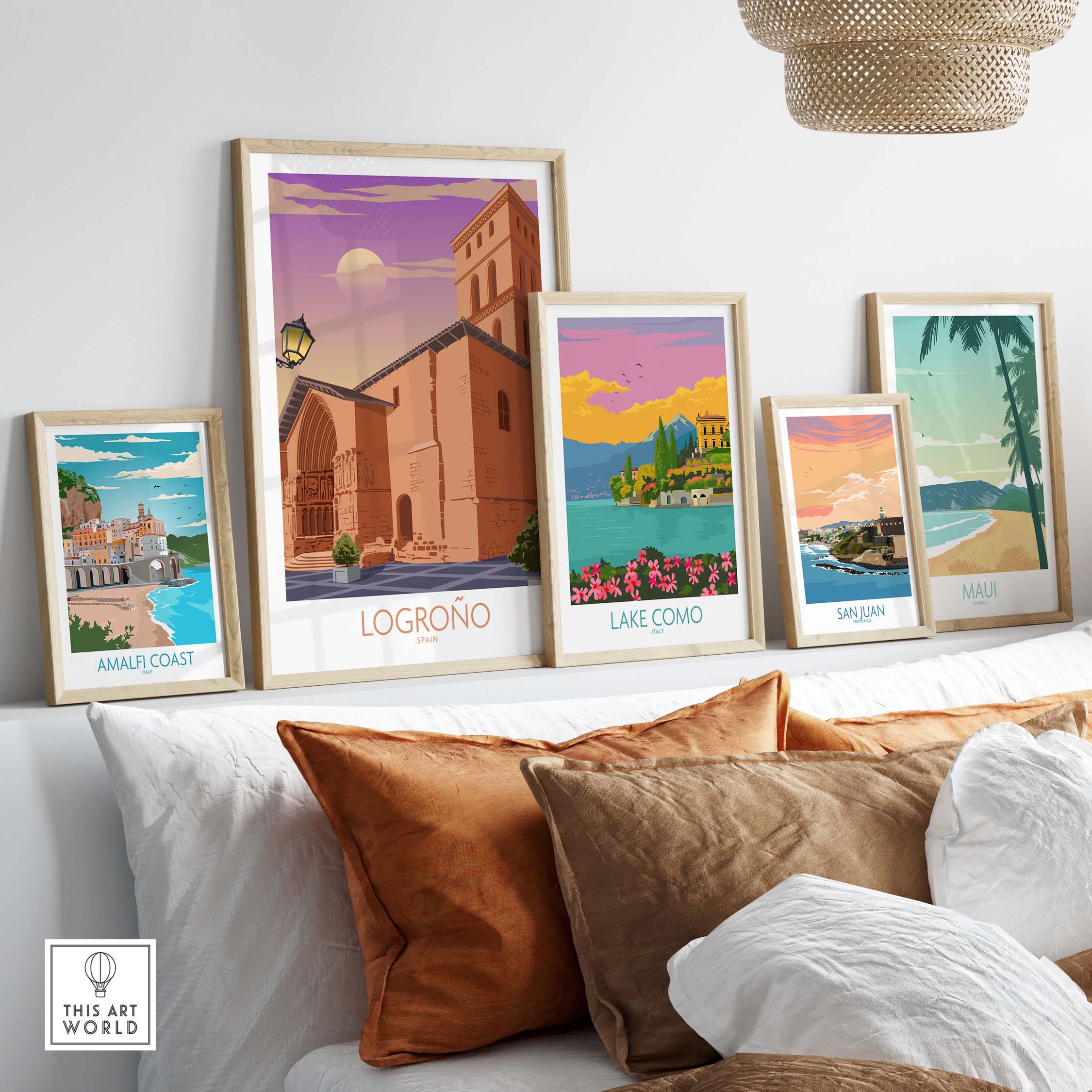 Logrono Spain poster and other vintage travel art displayed on a shelf with decorative pillows.