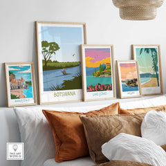 Colorful Botswana travel poster among framed artworks showcasing beautiful landscapes and destinations.