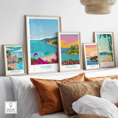 Stylish travel poster prints featuring Cannes and other scenic locations, displayed in a modern living room setting.