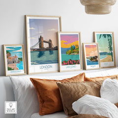 Collection of framed London and Italy travel art prints on a cozy sofa, showcasing vintage travel aesthetics.