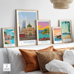 Melbourne poster art displayed on a stylish shelf, featuring vibrant travel destinations and framed prints.