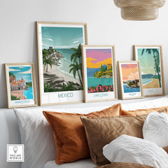 Stylish travel art prints including Mexico, Amalfi Coast, Lake Como, San Juan, and Maui displayed on a modern shelf.