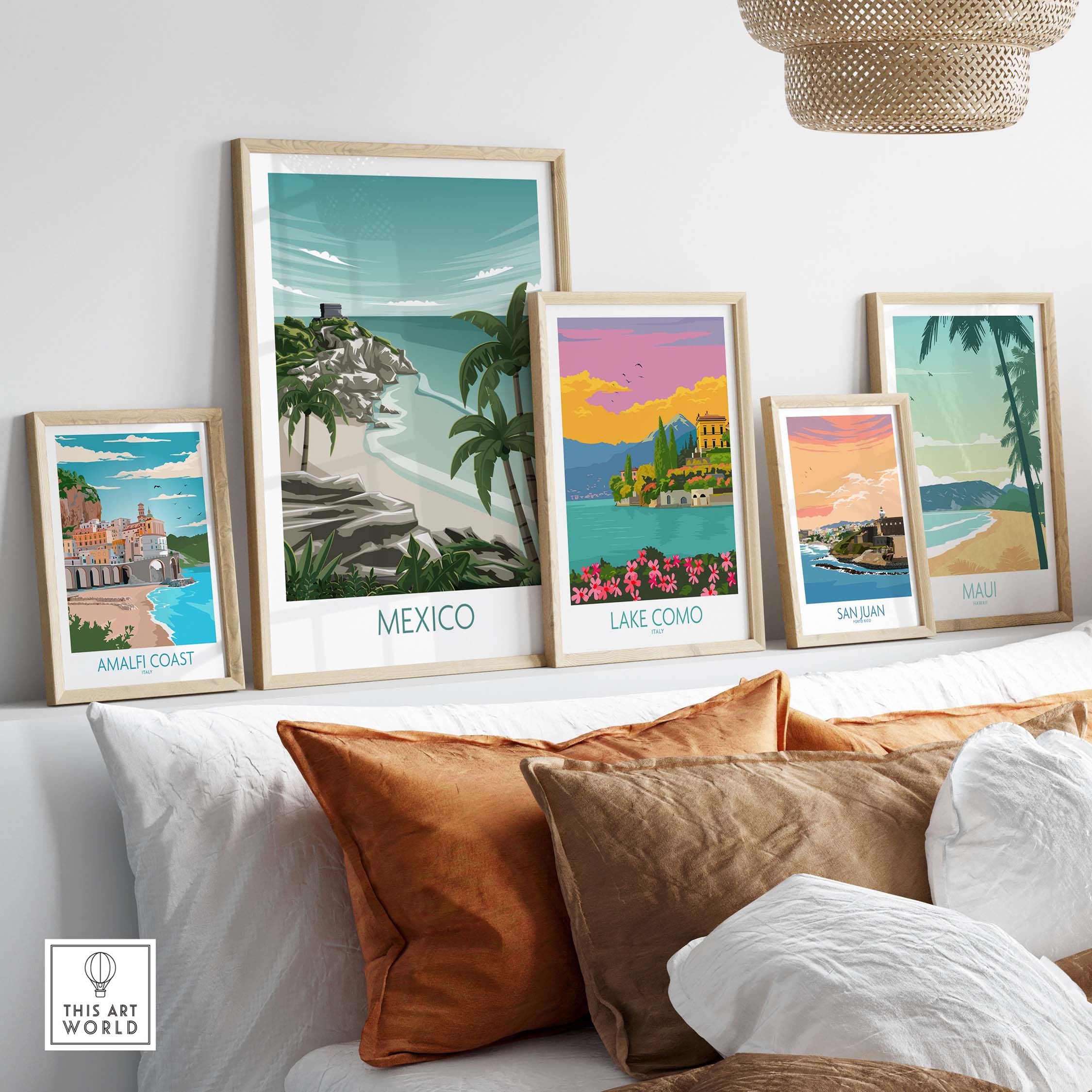 Stylish travel art prints including Mexico, Amalfi Coast, Lake Como, San Juan, and Maui displayed on a modern shelf.