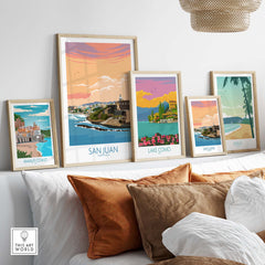 Collection of framed San Juan Puerto Rico and other travel prints on a stylish couch, showcasing beautiful wall art.