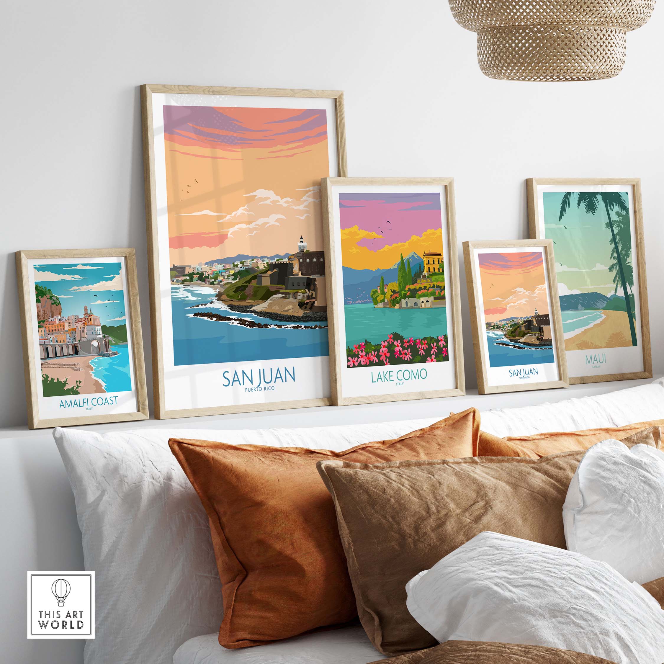 Collection of framed San Juan Puerto Rico and other travel prints on a stylish couch, showcasing beautiful wall art.