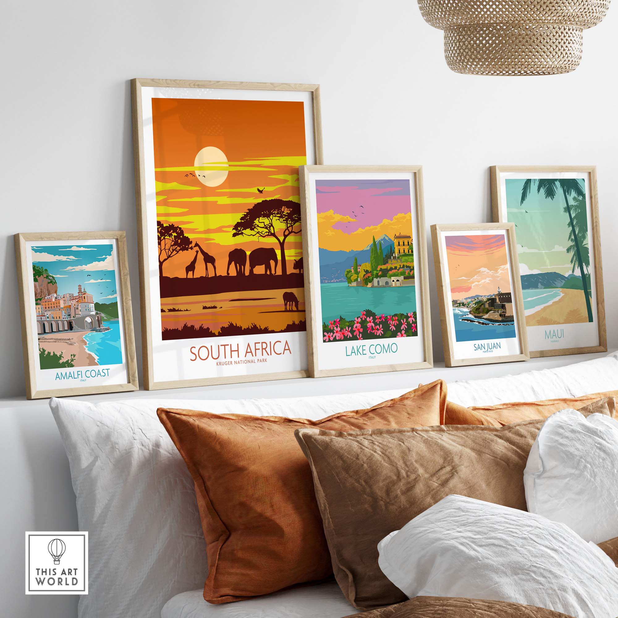 Stylish travel poster prints of South Africa's Kruger National Park and other destinations on a cozy sofa.