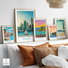 Auckland wall art prints displayed in stylish frames on a couch, showcasing nostalgic travel themes.
