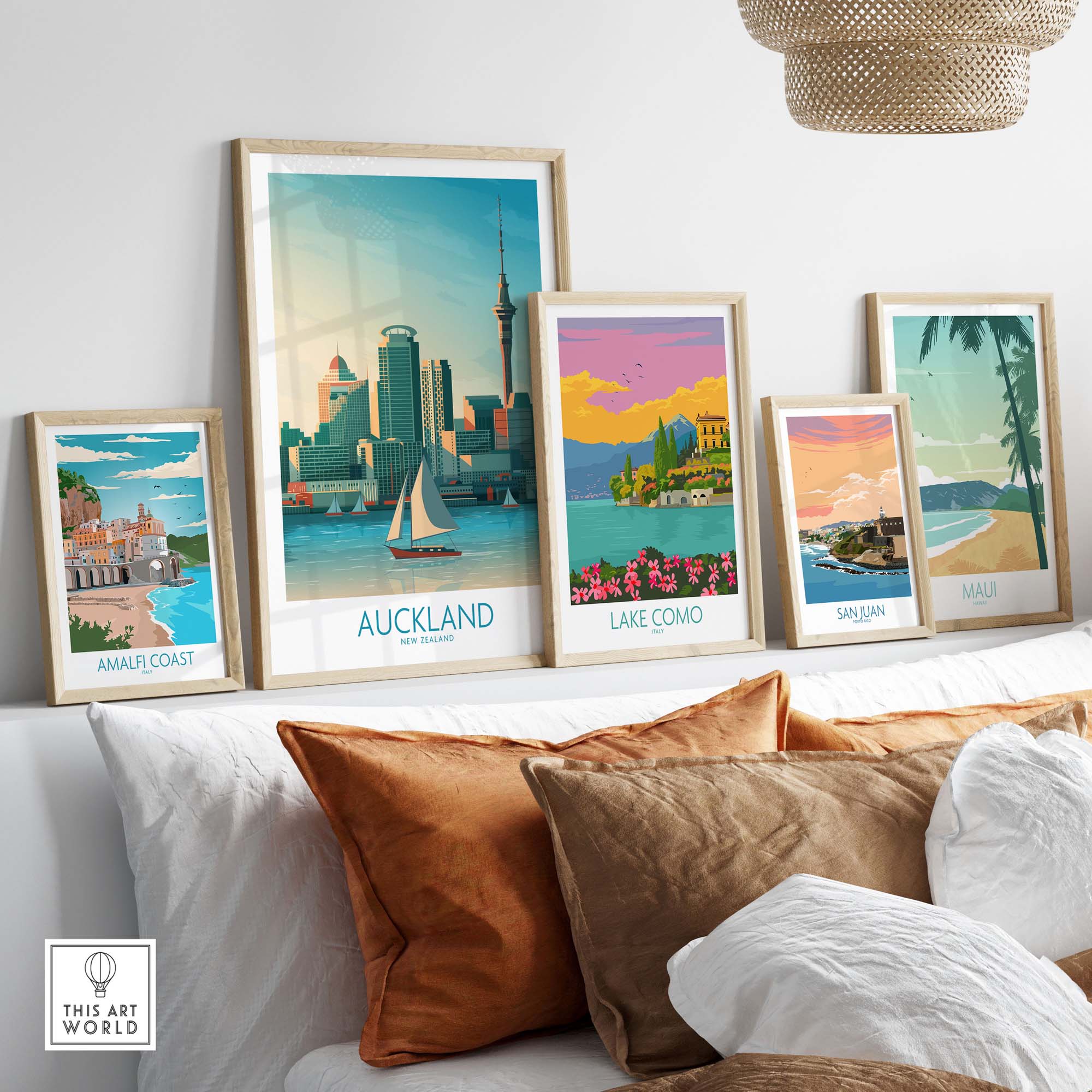 Auckland wall art prints displayed in stylish frames on a couch, showcasing nostalgic travel themes.