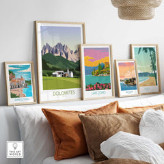 Framed Dolomites wall art print alongside other Italy travel posters on a stylish shelf.