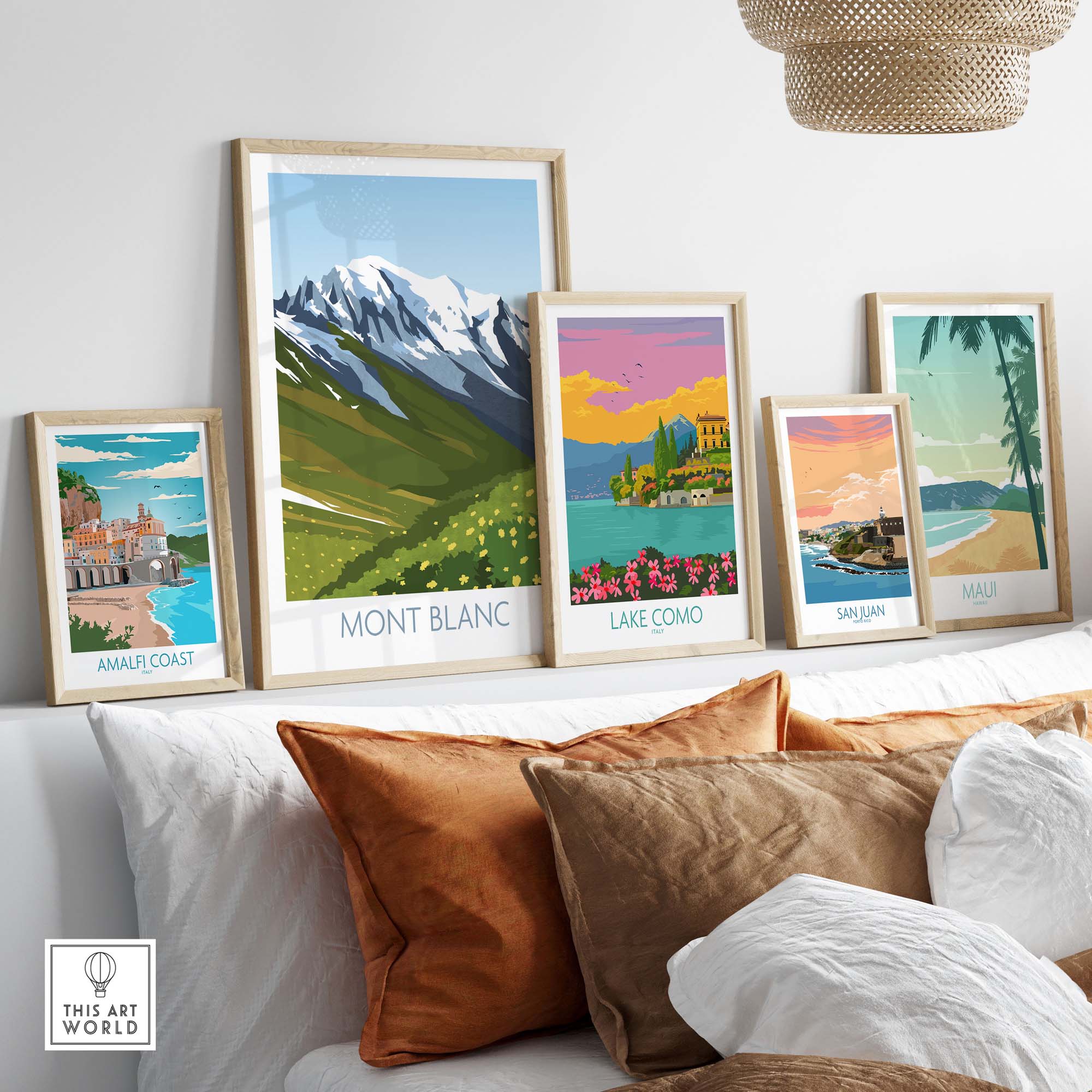 Framed Mont Blanc print and vintage travel posters on a stylish sofa, showcasing wanderlust decor.