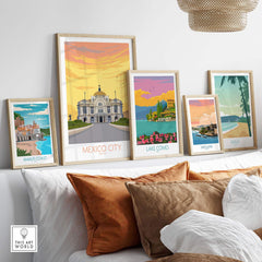 Stylish framed vintage travel posters including Mexico City, Lake Como, and Amalfi Coast, arranged decoratively on a shelf.