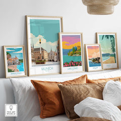 Stylish framed Munich travel poster among vintage travel art prints on a cozy living room wall.