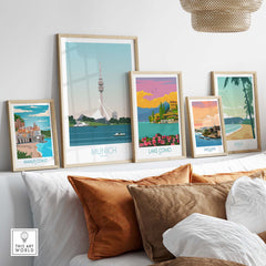 Stylish travel posters featuring Munich, Lake Como, and more, beautifully displayed on a sofa backdrop.