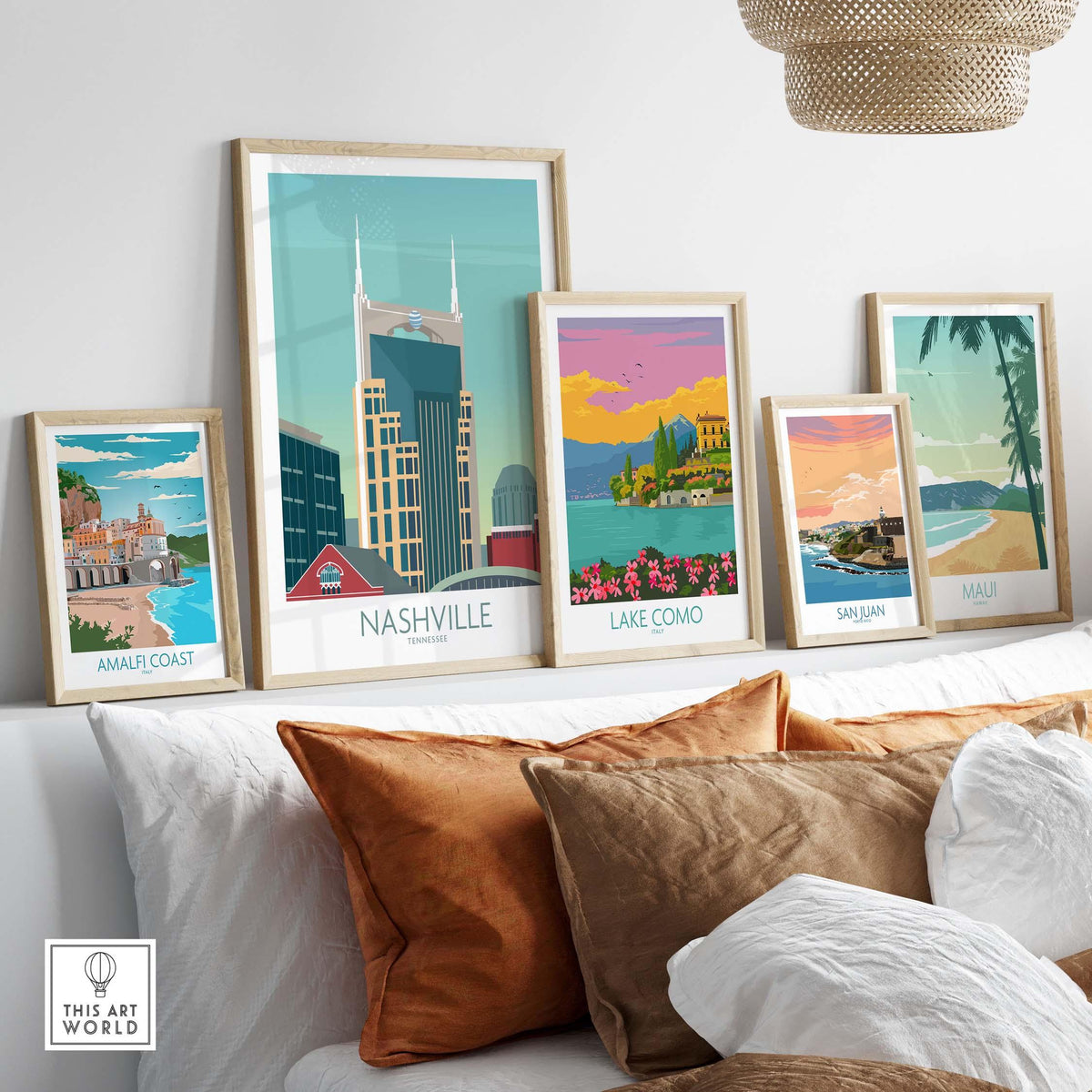 Collection of framed travel posters including Nashville, Lake Como, and Amalfi Coast on a stylish wall.