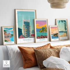 Collection of framed travel posters including Nashville, Lake Como, and Amalfi Coast on a stylish wall.