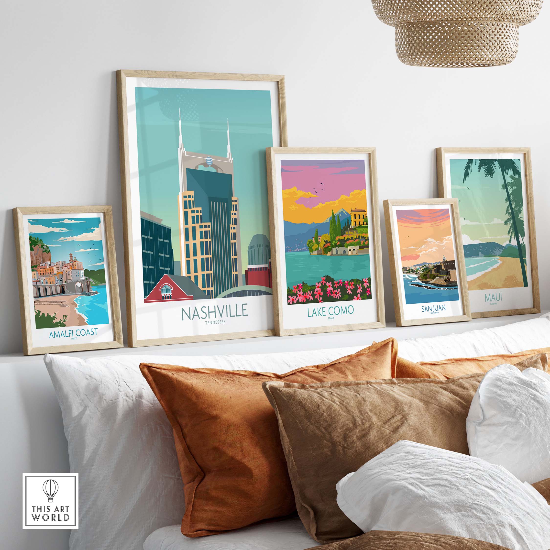 Collection of framed travel posters including Nashville, Lake Como, and Amalfi Coast on a stylish wall.