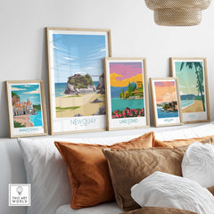Stylish Newquay Cornwall travel poster among vintage artwork on a cozy wall, showcasing wanderlust and travel inspiration.